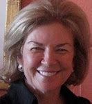 A woman smiling for the camera in a room