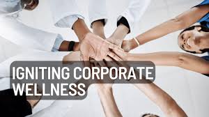 Hands of diverse team members stacked together symbolize collaboration and commitment to corporate wellness initiatives.